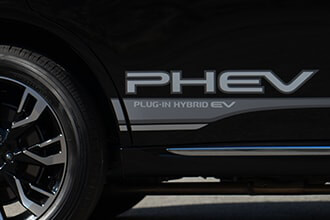 Close up image of the sauve black body of the Mitsubishi SUV PHEV highlighting the added elegance of the Side Decal Set.