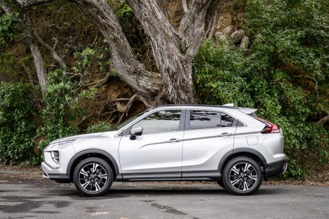 Side view of a Mitsubishi Eclipse cross in front of a cliff side