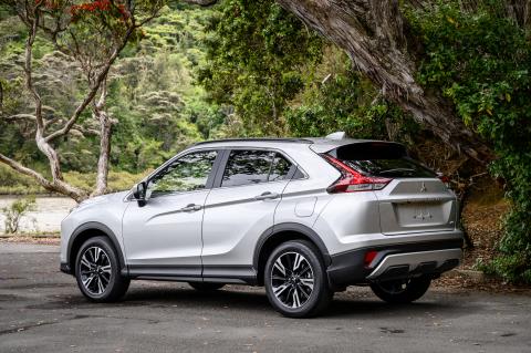 A Mitsubishi Eclipse Cross parked in front of a pohutukawa tree